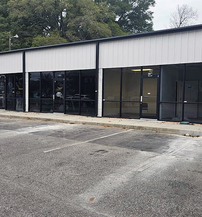 Commercial strip building exterior with updated paint by JBG Painting.