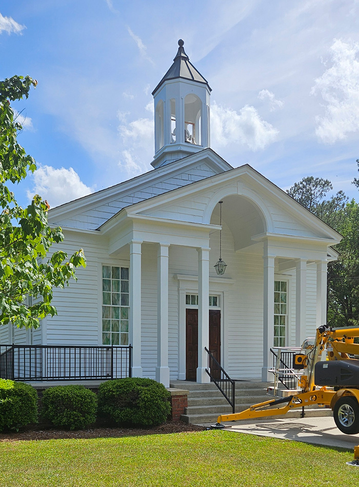 White church exterior with fresh paint and steeple restoration by JBG Painting.