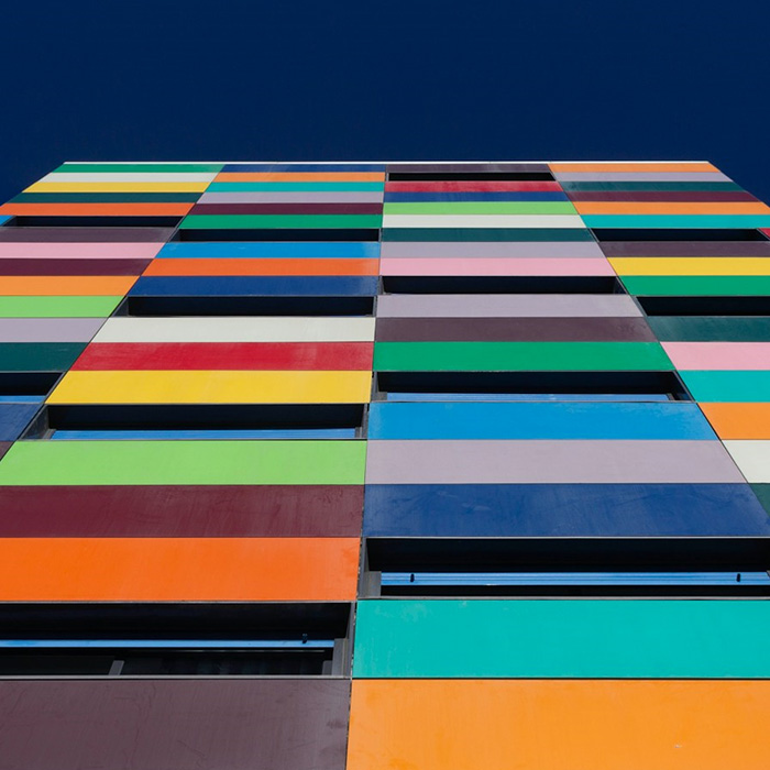 Bold striped exterior painted in vibrant shades by JBG Painting.