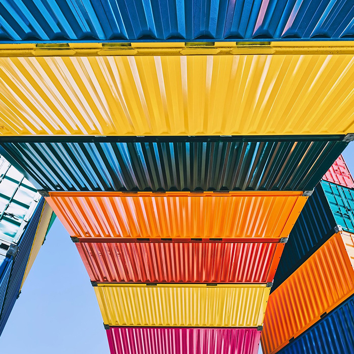 Brightly colored shipping containers stacked artistically, showcasing JBG Painting color inspiration.