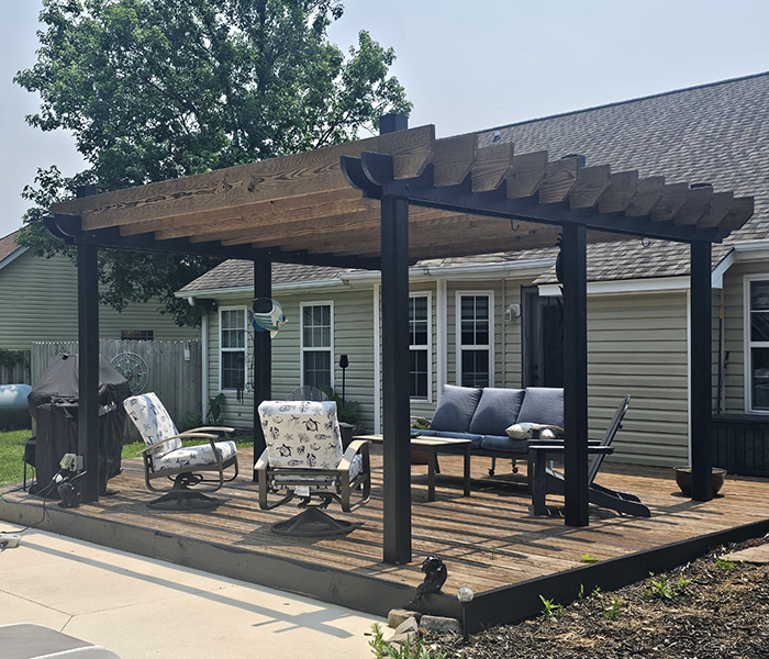 Custom outdoor pergola stained and finished by JBG Painting for backyard deck