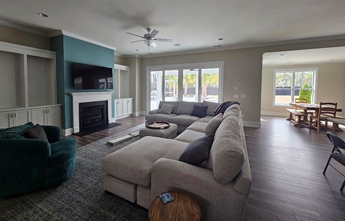 Bright open space showcasing a modern living room with sectional and view of dining area.