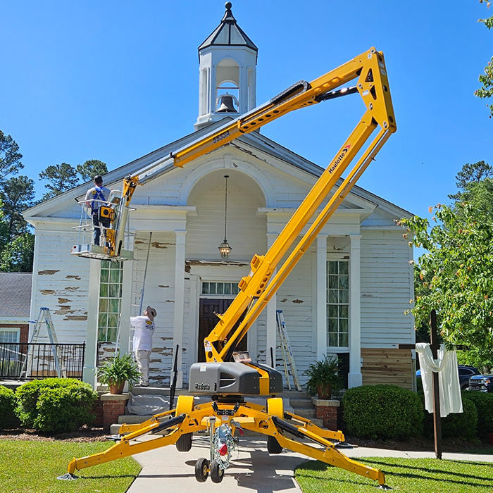 Historic church exterior restoration with JBG Painting crew using lift equipment