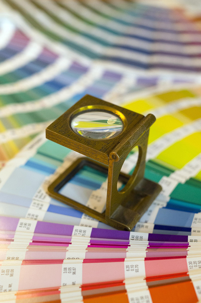 Magnifying tool over paint swatches for JBG Painting color consultations in Wilmington NC.