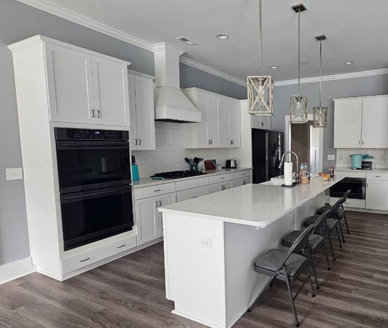 Updated kitchen cabinets painted in Wilmington NC by JBG Painting with modern white and blue finish.
