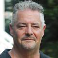Jeremy, part of the JBG Painting team, in a professional outdoor headshot with a blurred natural background.